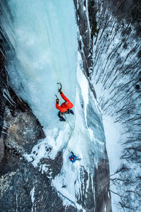 Man ice climbing on cathedral ledge in north conway, new hampshire