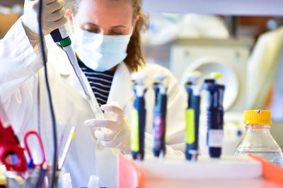 Female researcher working in laboratory with pipette