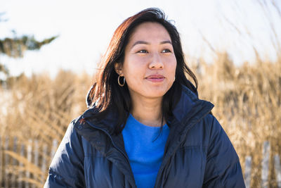 Closeup portrait of asian woman outdoors smiling at the beach