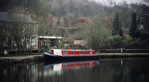 Boat in river with buildings in background