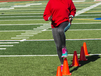 Low section of man running on soccer field