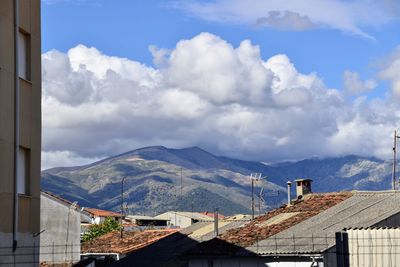 Buildings in town against sky