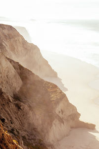 Scenic view of sea and mountains against sky