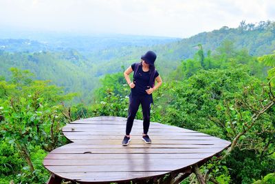 Full length of woman on mountain against sky