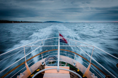 Cropped image of boat in sea against sky at dusk