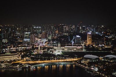 Illuminated cityscape against sky at night