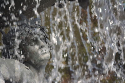 Close-up of statue against blurred water