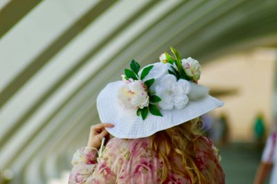 Rear view of woman wearing hat and flowers