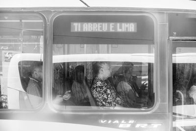 People seen through train window