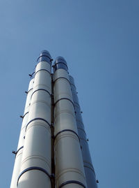 Low angle view of smoke stack against sky