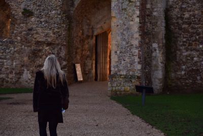 Rear view of woman walking in building