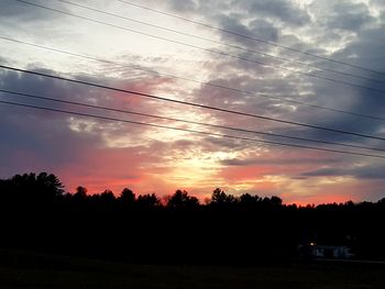 Silhouette trees against sky during sunset