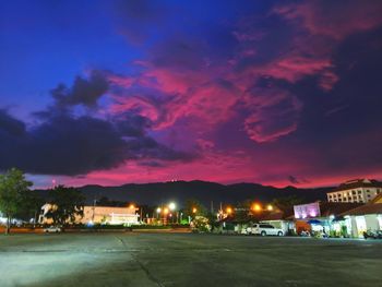 Illuminated buildings against sky at night