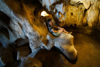 Full length of man on rock in cave