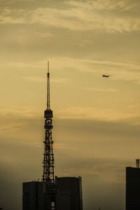 Low angle view of silhouette built structures against sky during sunset