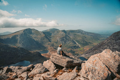 Man looking at mountain against sky