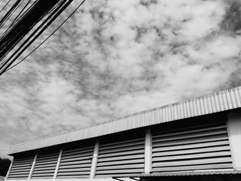 Low angle view of building against cloudy sky