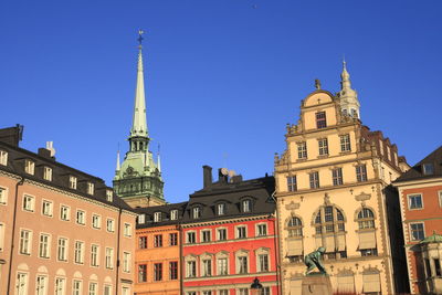 Low angle view of buildings against blue sky