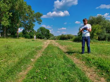 Full length of man standing on field against sky