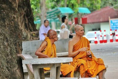 Monks relaxing on seat