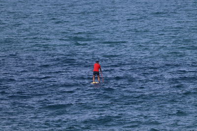 Rear view of man in sea
