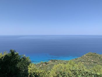 Scenic view of sea against clear blue sky