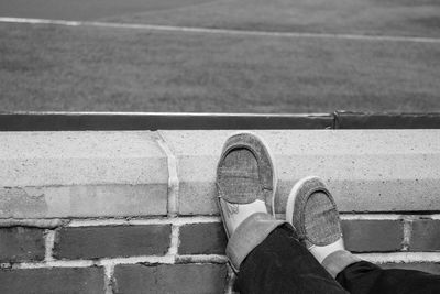 Low section of woman on retaining wall