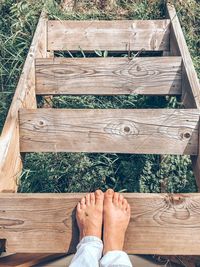 Low section of person standing on wooden steps