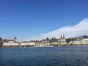 Buildings in city against blue sky