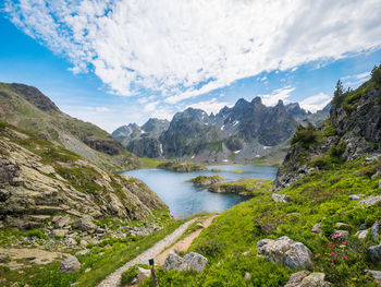 Scenic view of river amidst mountains against sky