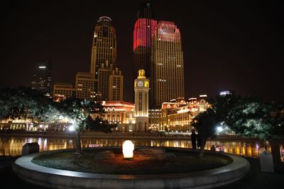 Illuminated buildings in city at night