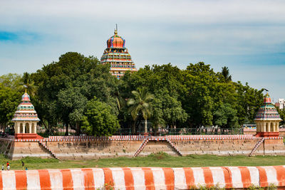 View of trees and building against sky