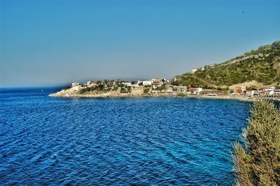 Scenic view of sea against clear blue sky