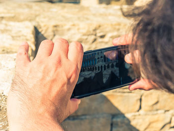 Midsection of man using mobile phone