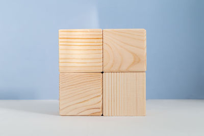 Close-up of wooden table against blue background