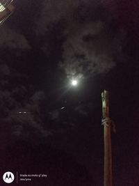 Low angle view of illuminated street light against sky