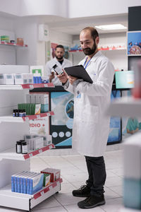 Portrait of young man standing in laboratory