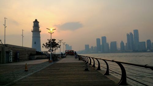 Illuminated bridge leading towards sea