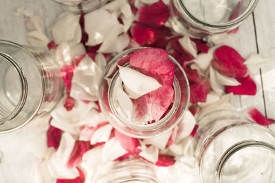 Directly above shot of rose petals in glass jar on table