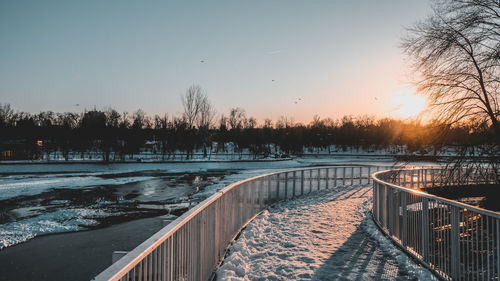 Scenic view of lake against clear sky during winter