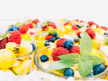 Close-up of fruits in bowls against white background