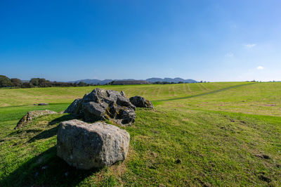 Scenic view of rocks on field against sky