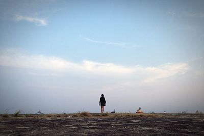 Rear view of man standing on landscape