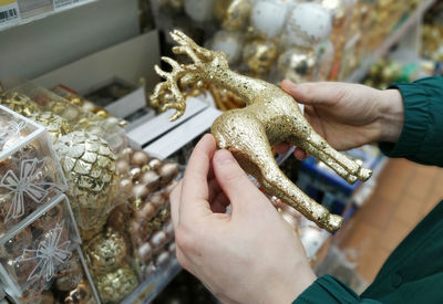 Close-up of man holding hands at store