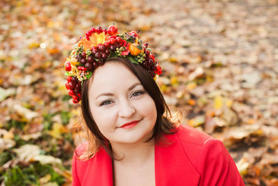 Portrait of beautiful woman against red wall