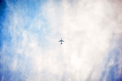 Low angle view of airplane flying in sky
