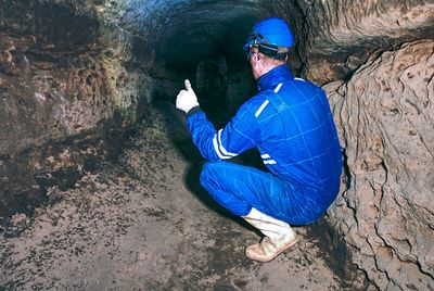 High angle view of man sitting on rock