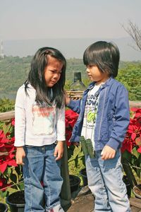 Siblings standing at observation point