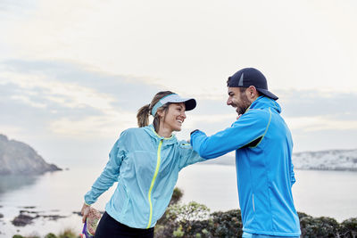 Happy couple doing stretching exercise