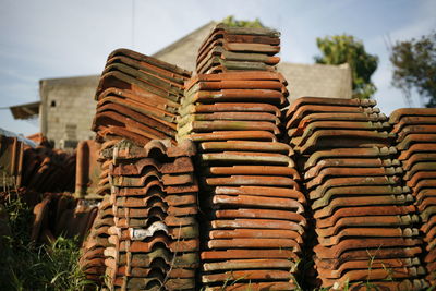 Stack of roof tiles against building